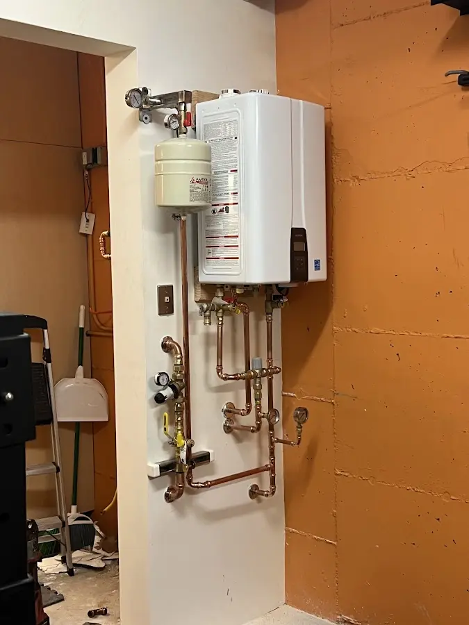 Plumbing technician inspecting water heater connections in Florida City
